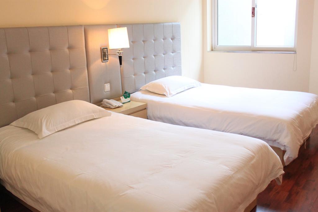 Qingdao Renjia Bussiness Hotel Quarto foto